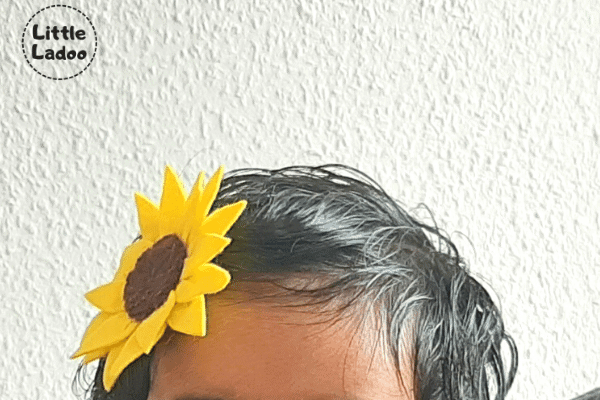 Child wearing a DIY sunflower hairclip