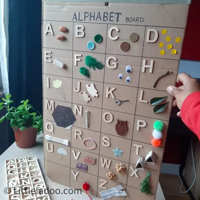 alphabet board with everyday objects